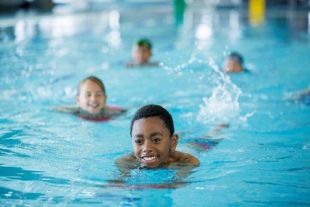 Four children in a swimming pool