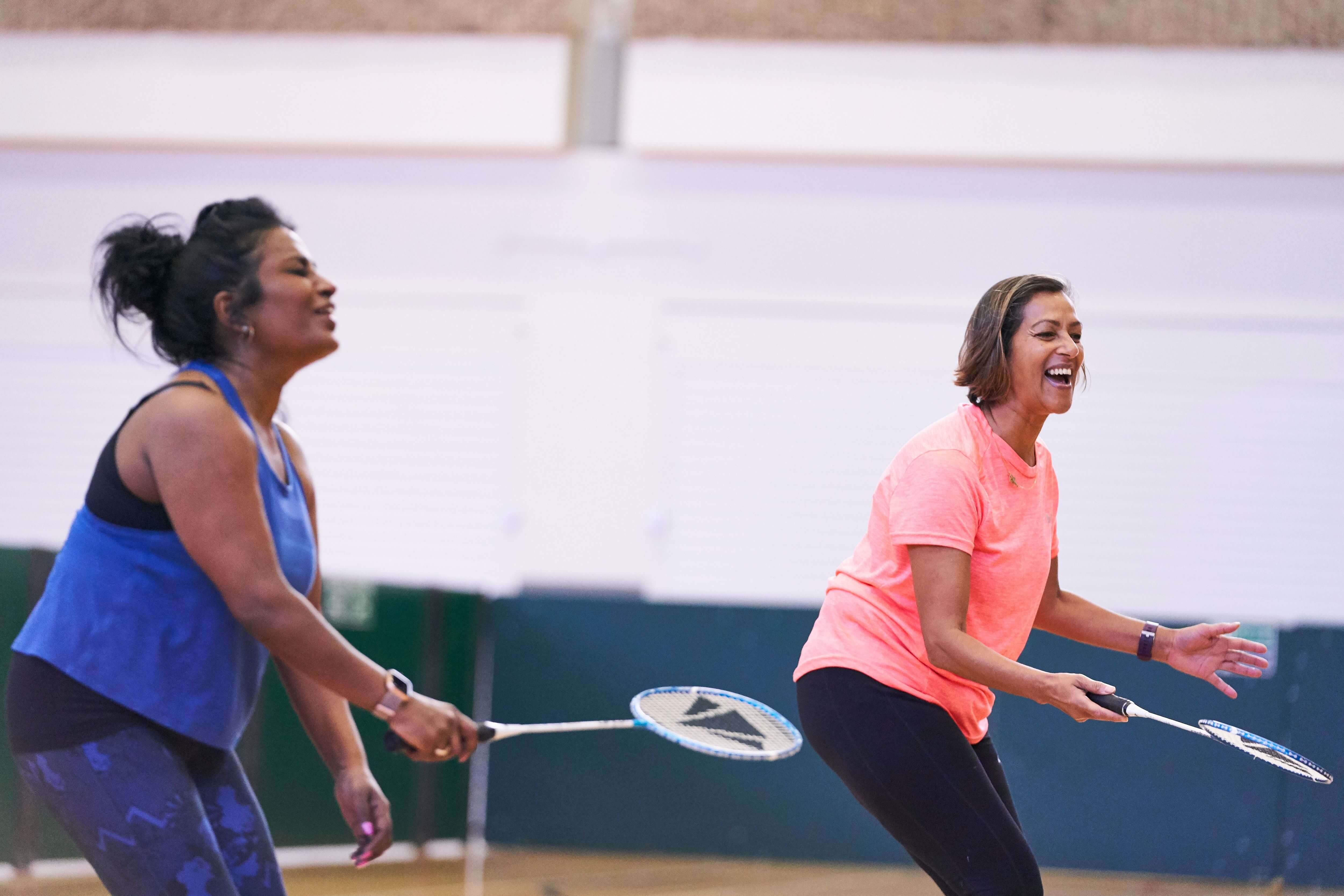 Two ladies playing badminton